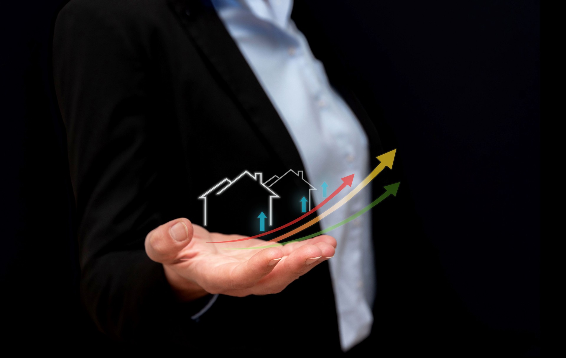 Close up of Real estate agent showing open hand with increasing house values with upward trend arrows on black background